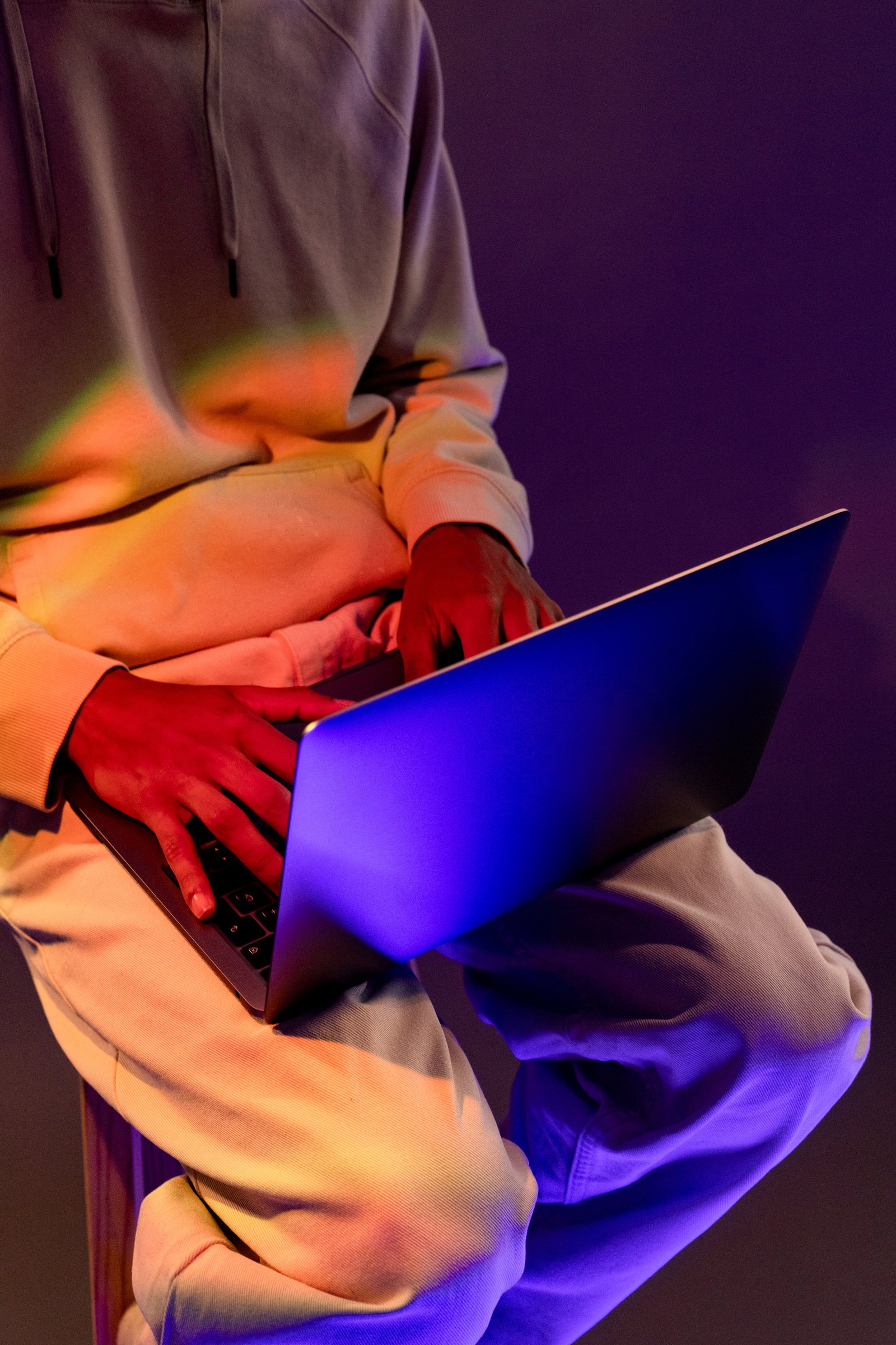 a person sitting on a chair with a laptop in front of them